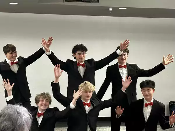 The Company male group hands in air
